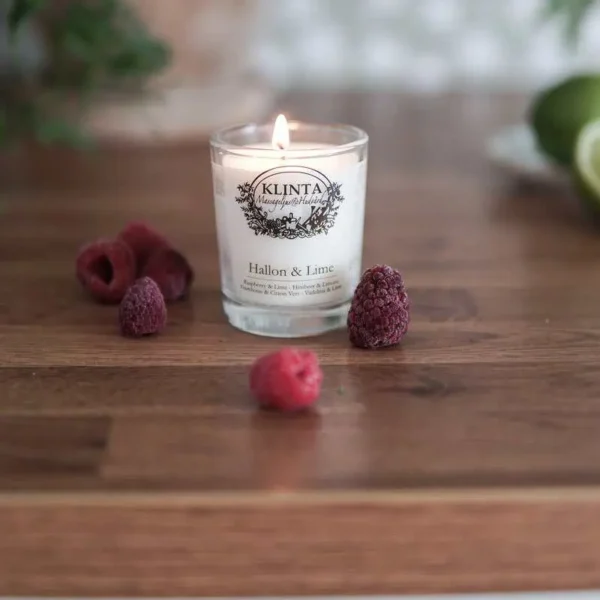 Klinta massageljus Hallon & Lime med tillhörande ask, dekorerat med hallon, lime och gröna blad.