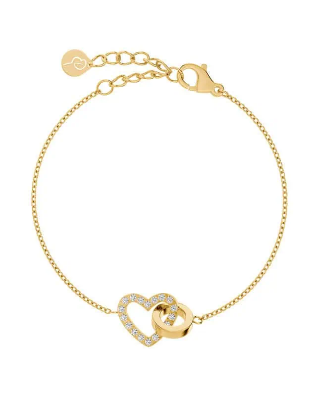 Armband i guld med hjärta dekorerat med klara stenar och en slät ring, från Edblad. Justerbar kedja med lås och logoberlock.