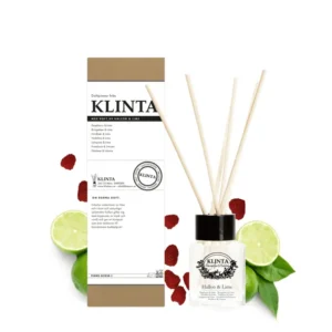 Klinta doftpinnar Hallon & Lime i glasflaska med träpinnar och kartongförpackning, omgiven av hallon, lime och gröna blad.